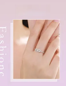 Model wearing a delicate S925 sterling silver infinity ring with sparkling pavé cubic zirconia