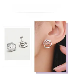 Detail display of silver geometric hexagonal earrings featuring white cubic zirconia accents