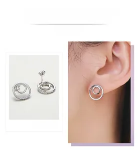 Close-up of double round s925 silver stud earrings with micro-pave cubic zirconia accents
