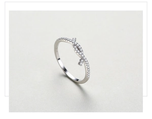 Macro shot of s925 silver ring featuring micro-pave diamonds and a knot design