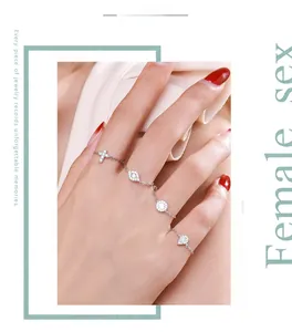 Detail of s925 silver chain ring set with CZ stones featuring cross and eye charms