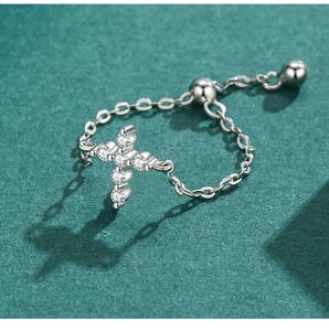 Macro shot of s925 silver cross ring featuring sparkling cubic zirconia and adjustable chain