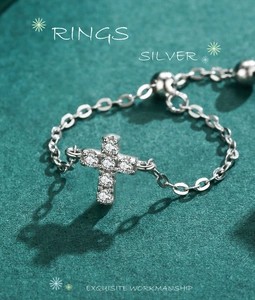 Macro detail of S925 silver cross ring with sparkling zircon stones and adjustable chain