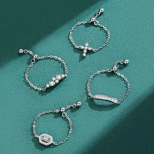 Adjustable S925 silver chain rings with geometric zircon pendants on green background