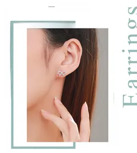 Close-up of elegant s925 silver bow stud earrings with micro-set cubic zirconia on ear