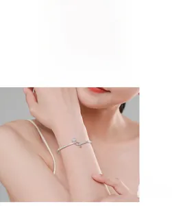 Close-up of minimalist S925 silver bracelet with sparkling diamond sphere on wrist