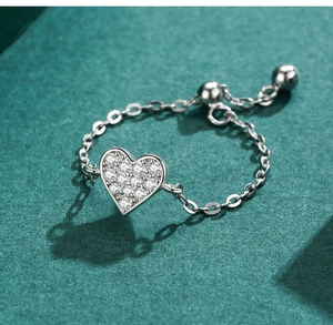 Detail of adjustable S925 silver heart ring with micro-paved crystals and chain link band