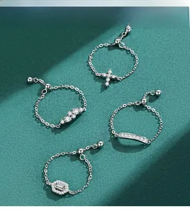 Close-up of four adjustable S925 silver chain rings with cross and zircon accents