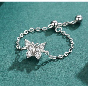 Macro detail of S925 silver butterfly ring with cubic zirconia and adjustable chain