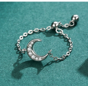 Macro shot of silver crescent moon ring with micro-pave zircons and adjustable chain
