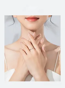 Detail showing minimalist 925 silver ring with zircon inlay worn on model's finger