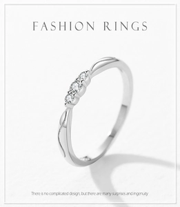 Detail of s925 silver ring featuring three micro-set zircons and wave textured band