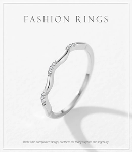Close-up of wavy 925 silver ring featuring micro-pave zircon stones on wave crests