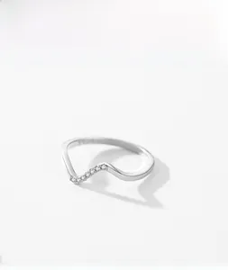 Macro shot of 925 sterling silver wavy ring with small white crystals and S925 engraving