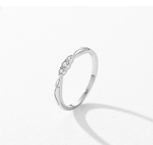 Detailed view of S925 sterling silver ring with three micro-set zircons on white background