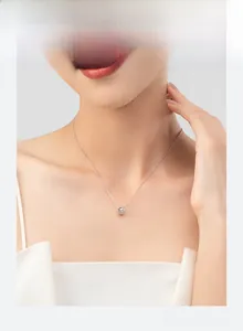 Detail of s925 silver cylinder pendant necklace with diamond-set lattice pattern on model