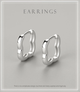 Detailed view of flower-shaped S925 sterling silver hoop earrings with high polish finish