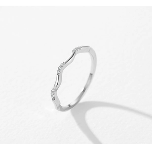 Macro detail of wave-shaped 925 silver ring with sparkling micro-inlaid cubic zirconia