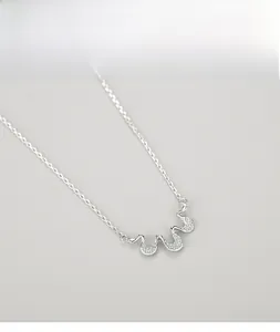 Macro shot of silver S925 sterling silver wavy pendant featuring micro-set sparkling diamonds