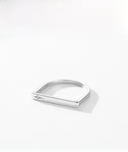 Macro shot of S925 sterling silver ring featuring a star-set zircon on a flat rectangular band