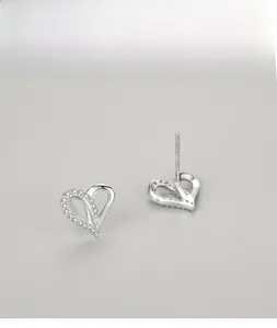Detailed macro of S925 sterling silver heart earrings with micro-pave zirconia crystals