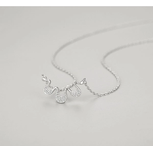 Macro shot of S925 sterling silver wavy pendant necklace with shimmering micro zircon stones