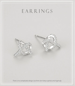 Macro detail of silver crossover knot earrings with micro-pave cubic zirconia crystals