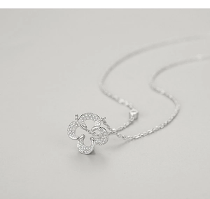 Macro detail of a 925 silver leaf pendant necklace with micro-pave cubic zirconia crystals