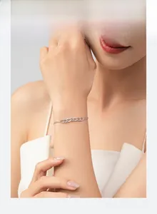 Detailed shot of double-layered silver chain bracelet with micro-paved zircon accents