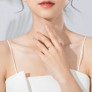 Elegant 925 sterling silver wavy ring with small zircons shown on a female hand
