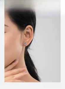 Close-up of s925 silver planet stud earring with moonstone and pavé crystals on ear