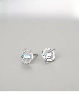 Macro view of S925 silver planet stud earrings with moonstone and cubic zirconia details