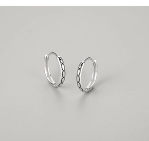 Detailed view of S925 sterling silver hoop earrings with black oval engraved patterns