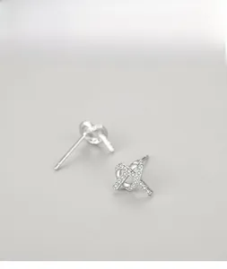 Detailed view of silver S925 stud earrings with micro-paved sparkling zircon cross knot