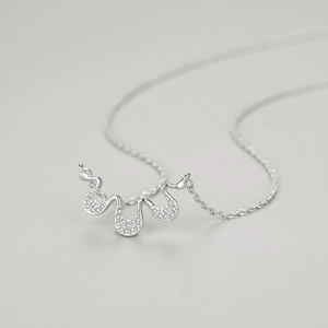 Elegant S925 sterling silver necklace featuring a wavy geometric pendant with pavé diamonds