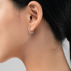 Polished S925 silver heart shaped hoop earrings for women on model with minimalist design