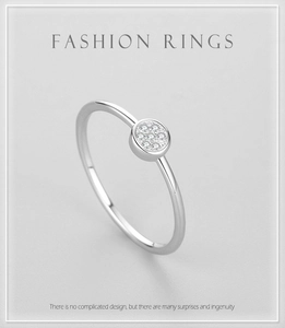 Close-up of a s925 silver ring featuring a round pave-set cubic zirconia centerpiece