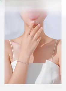 Detail of silver S925 paperclip link chain bracelet on wrist with elegant sleek finish