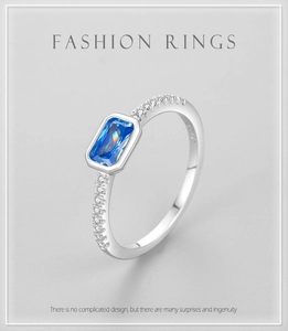 Detail of S925 sterling silver ring featuring emerald-cut blue zircon and pavé diamonds