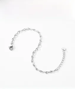 Close-up of minimalist S925 silver infinity chain with lobster clasp and round tag