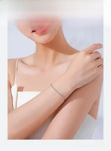 Close-up of minimalist s925 silver twist bracelet worn on a female wrist for a chic look