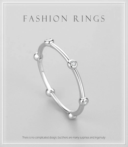 Detail view of a minimalist S925 silver ring featuring six round inlaid zircons