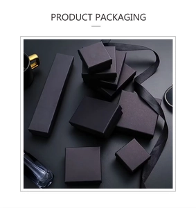 Elegant matte black jewelry packaging set with ribbon accents for rings and necklaces