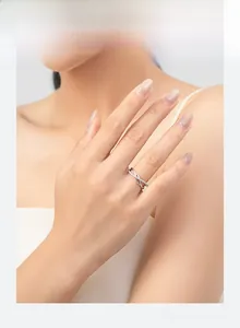 Detail of s925 silver criss-cross ring with micro-pave cubic zirconia on model finger