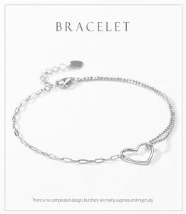 Macro detail of s925 silver heart bracelet showing bead chain and lobster clasp