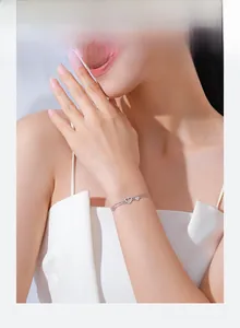 Detail of s925 silver double layer heart bracelet with cubic zirconia on female wrist