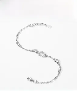 Detailed view of S925 sterling silver double chain heart bracelet with pavé cubic zirconia