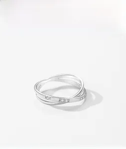 Close-up of S925 silver crossover ring featuring pavé set cubic zirconia stones