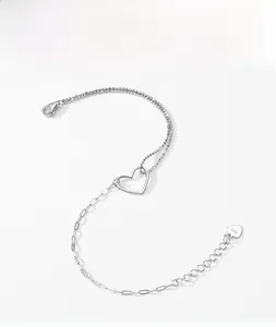 Detail of s925 silver bracelet featuring heart pendant and dual-chain texture design