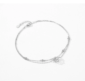 Detail of s925 silver double-layered anklet with star charm and pavé zircon stones